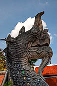 Chiang Mai - The Wat Chedi Luang, detail of the head of naga-makara guardian at the entrance of a secondary vihan. 